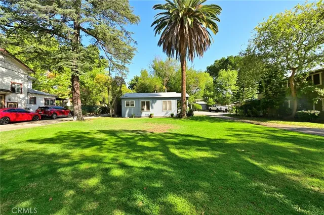 a front view of house with yard and green space