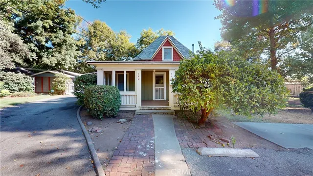 a view of a house with brick walls and a yard