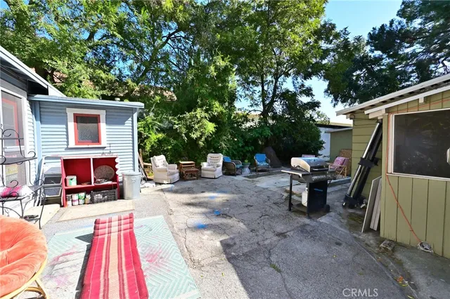 a view of a patio with table and chairs with wooden floor and fence