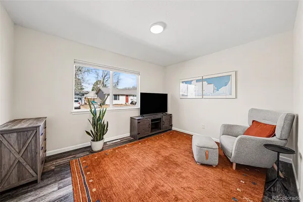 a bedroom with furniture and a flat screen tv