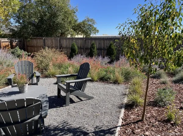 a view of a chairs and table in a backyard