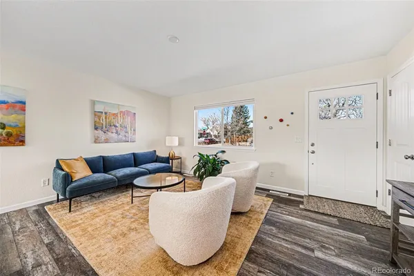 a living room with furniture and a rug