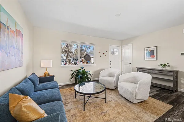 a living room with furniture a rug and a table