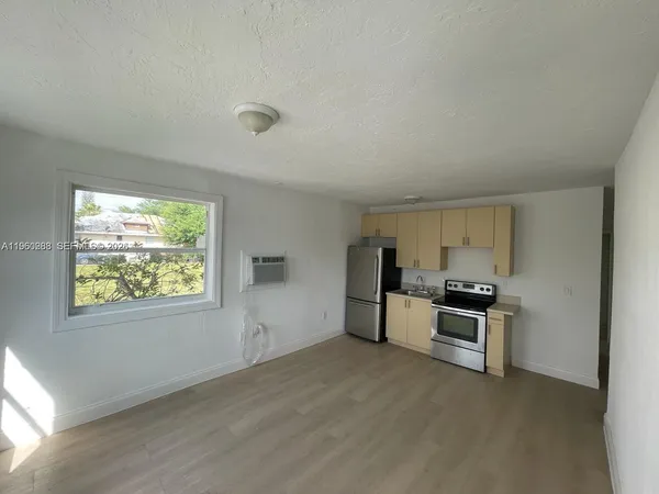 a view of a kitchen with a sink stove and a window