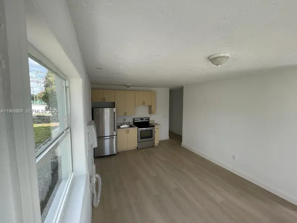 a view of a kitchen with a sink and dishwasher stove top oven