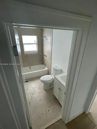 a bathroom with a bathtub and toilet