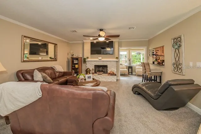 a living room with furniture fireplace and flat screen tv