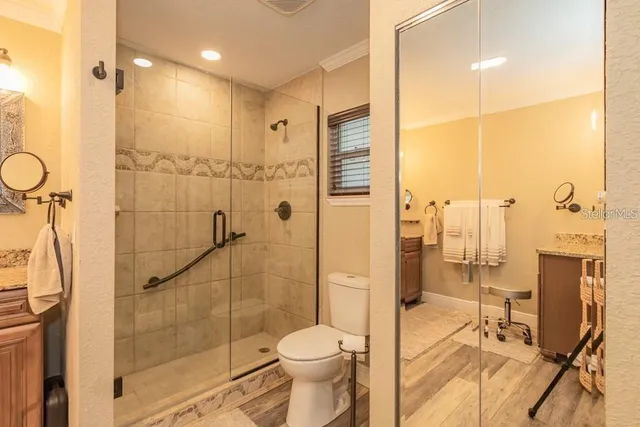 a bathroom with a toilet and a shower