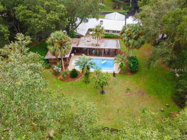 an aerial view of a house with a yard