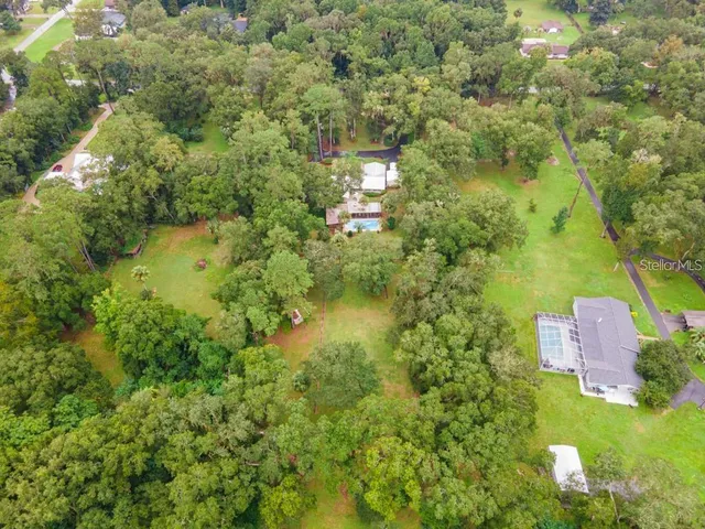 an aerial view of a house with a yard