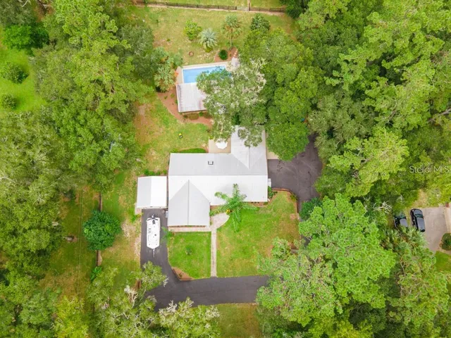 a view of a swimming pool and trees in the background