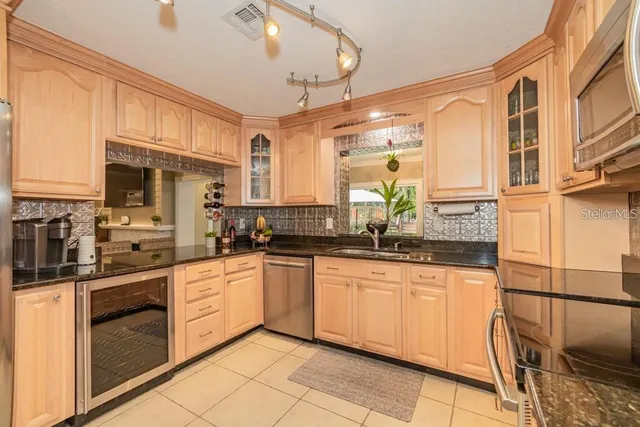 a kitchen with stainless steel appliances granite countertop a sink and cabinets