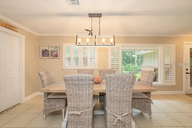 a view of a dining room with furniture large windows and wooden floor