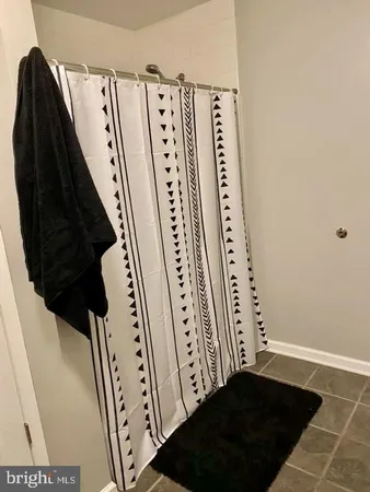 a view of a closet with wooden floor