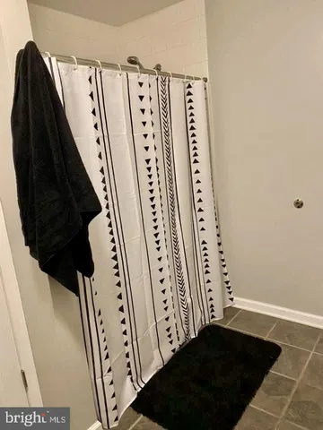 a view of a closet with wooden floor