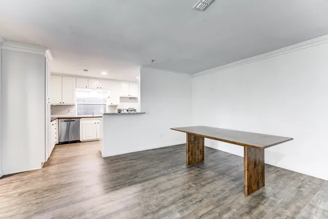 a view of kitchen with wooden floor and electronic appliances
