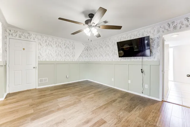 a view of an empty room with a flat screen tv