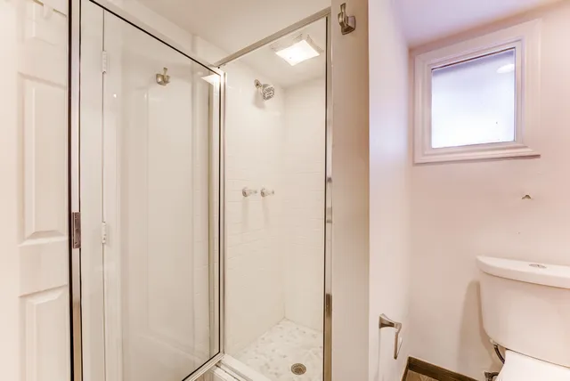 a bathroom with a shower and a toilet