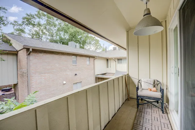 a balcony view with a couple of chairs