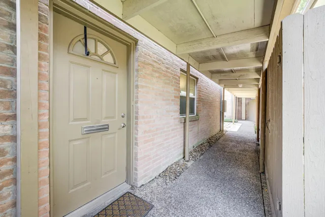 a view of a front door and wooden floor