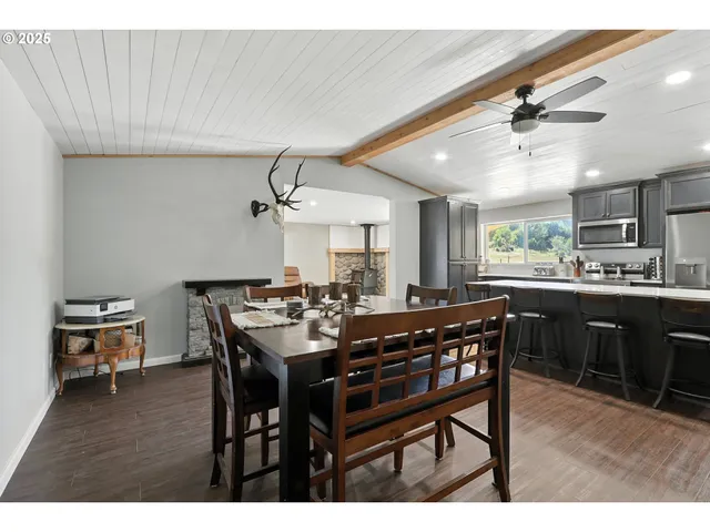 a view of a dining room with furniture and a chandelier