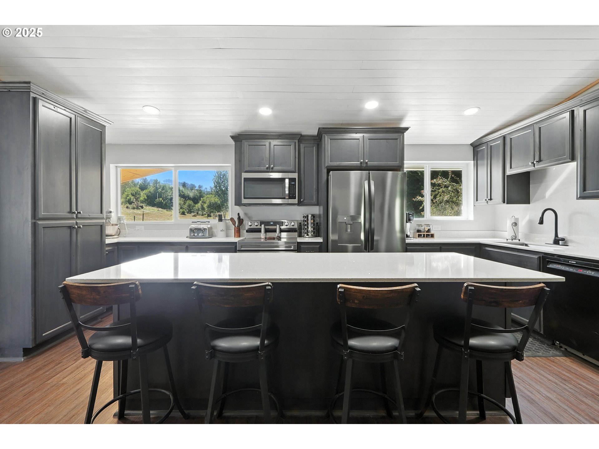 22404 Northeast Dole Valley Road Yacolt, WA 98675 - Photo 15 of 45 a kitchen with stainless steel appliances granite countertop a sink and chairs