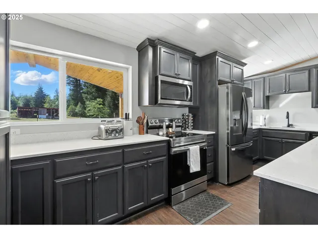 a kitchen with a sink stove and refrigerator