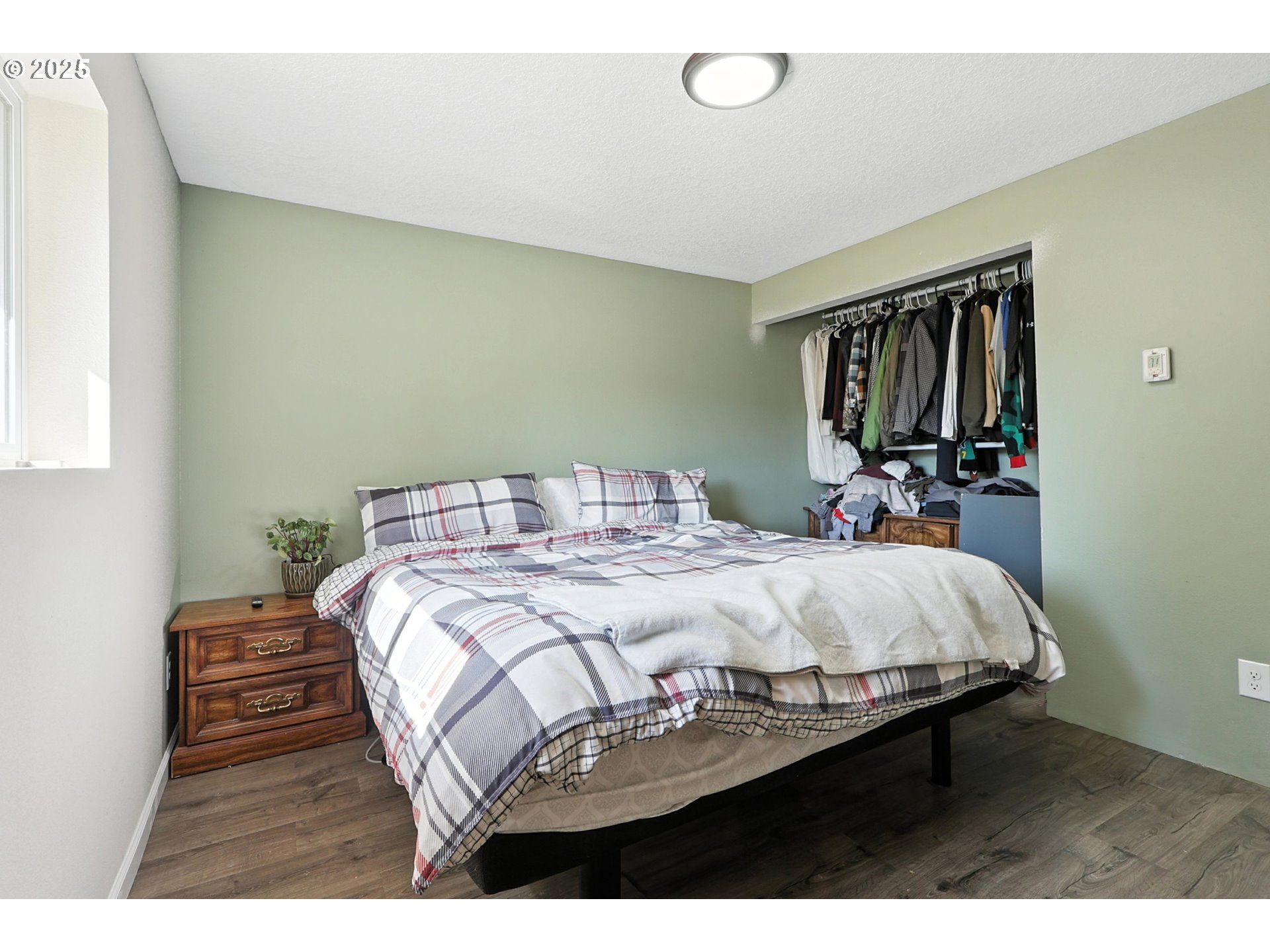 22404 Northeast Dole Valley Road Yacolt, WA 98675 - Photo 26 of 45 a bedroom with a bed and wooden floor