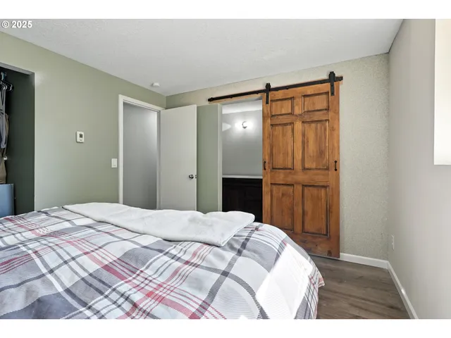 a bed room with a bed and a mirror