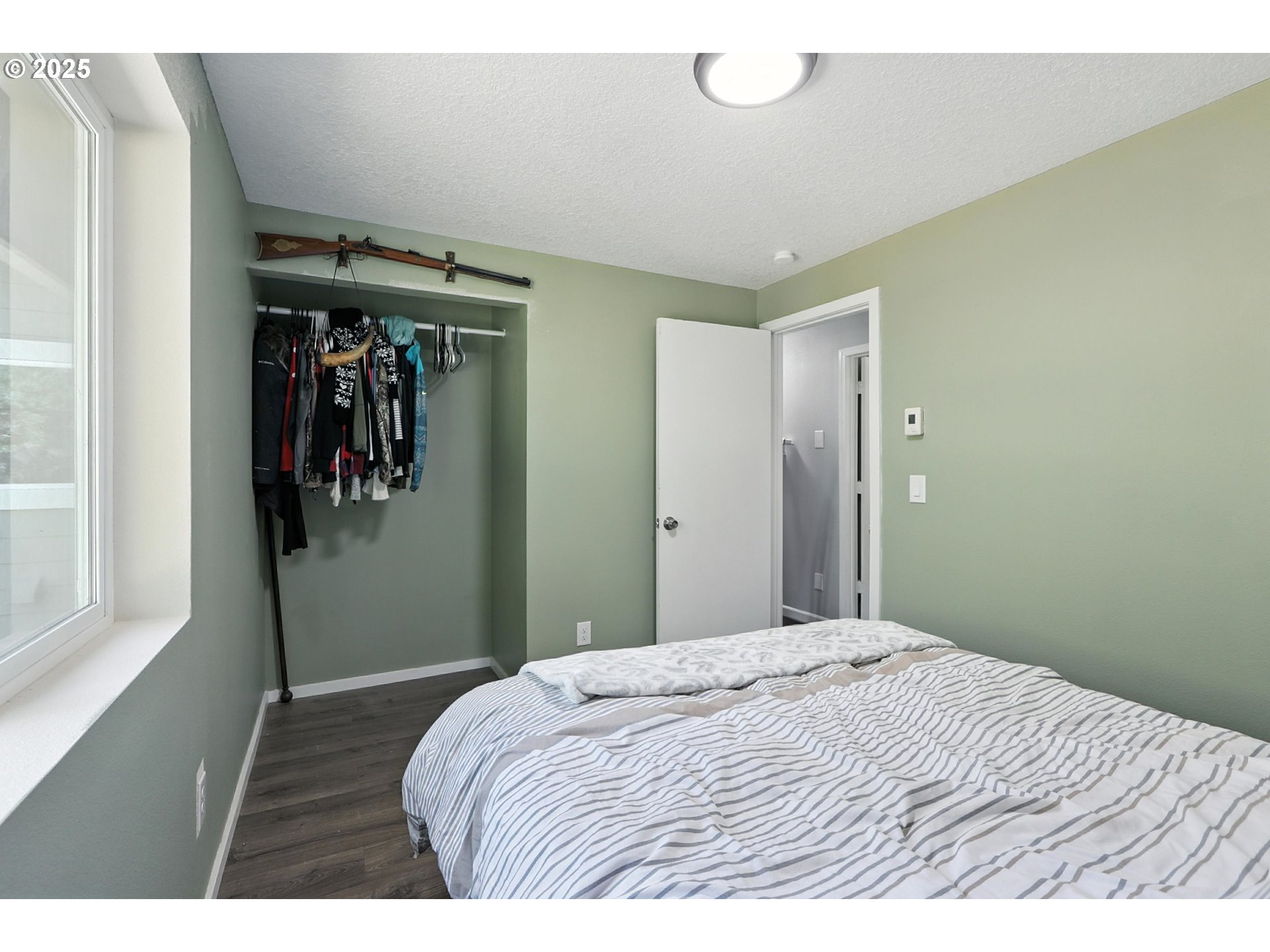 22404 Northeast Dole Valley Road Yacolt, WA 98675 - Photo 31 of 45 a bedroom with a bed and a window