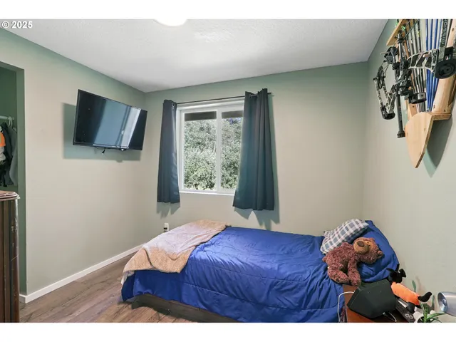 a bedroom with a bed and a flat screen tv