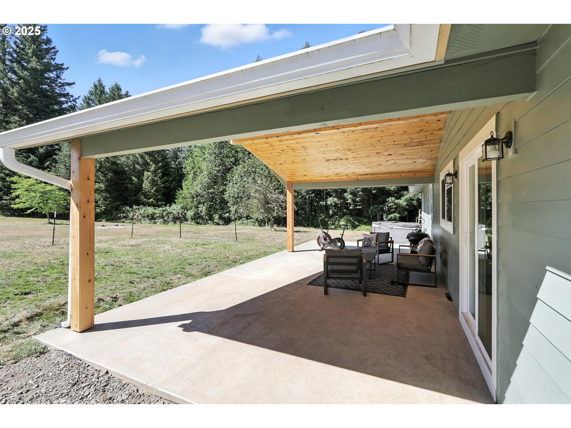 22404 Northeast Dole Valley Road Yacolt, WA 98675 - Photo 38 of 45 a view of a patio with table and chairs potted plants with floor to ceiling window