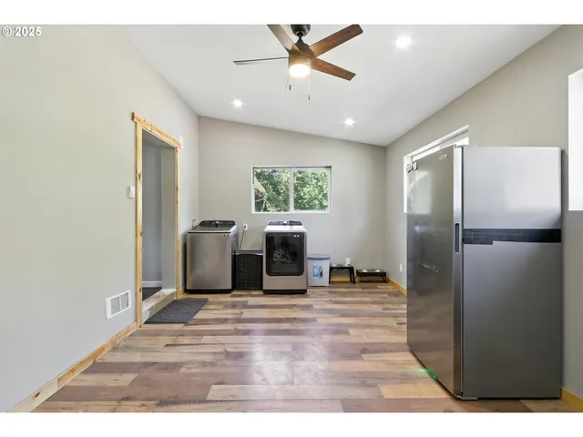 a living room with furniture window and a ceiling fan