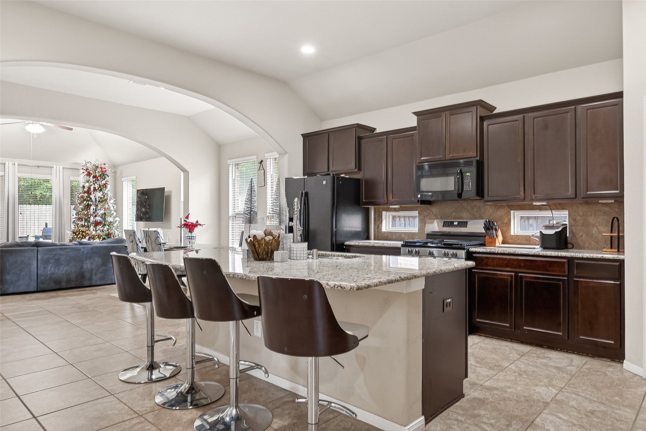 22530 Forbes Field Trail Spring, TX 77389 - Photo 14 of 50 a kitchen with stainless steel appliances granite countertop a stove top oven a sink dishwasher a dining table and chairs