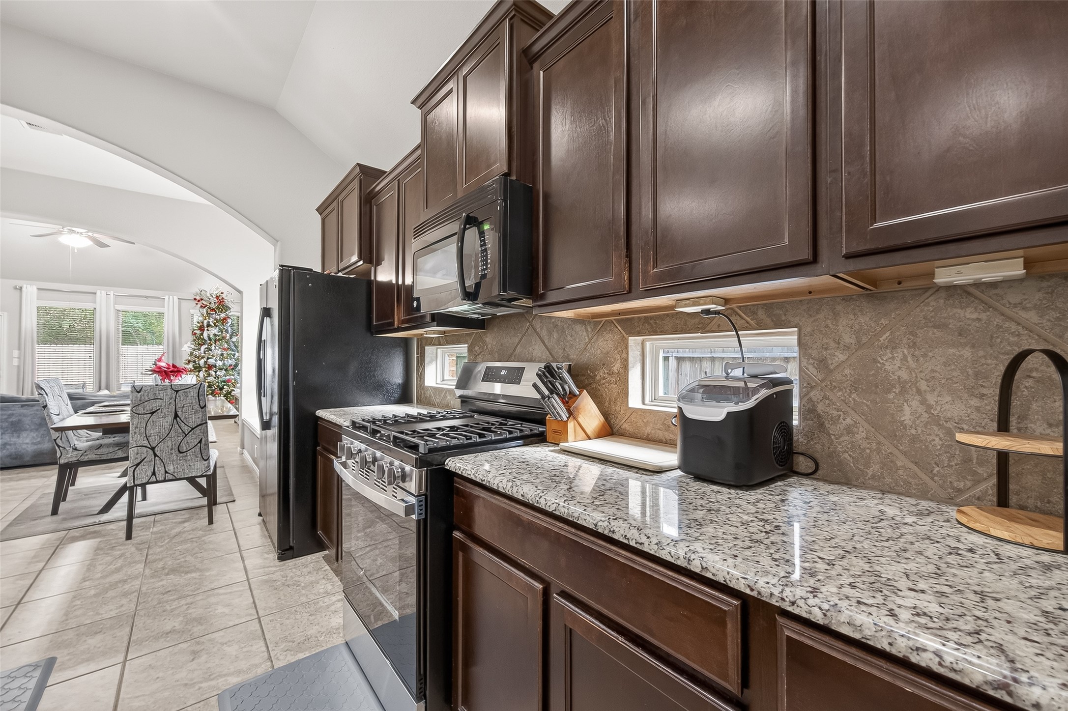 22530 Forbes Field Trail Spring, TX 77389 - Photo 17 of 50 a kitchen with granite countertop stainless steel appliances a sink a counter space and cabinets
