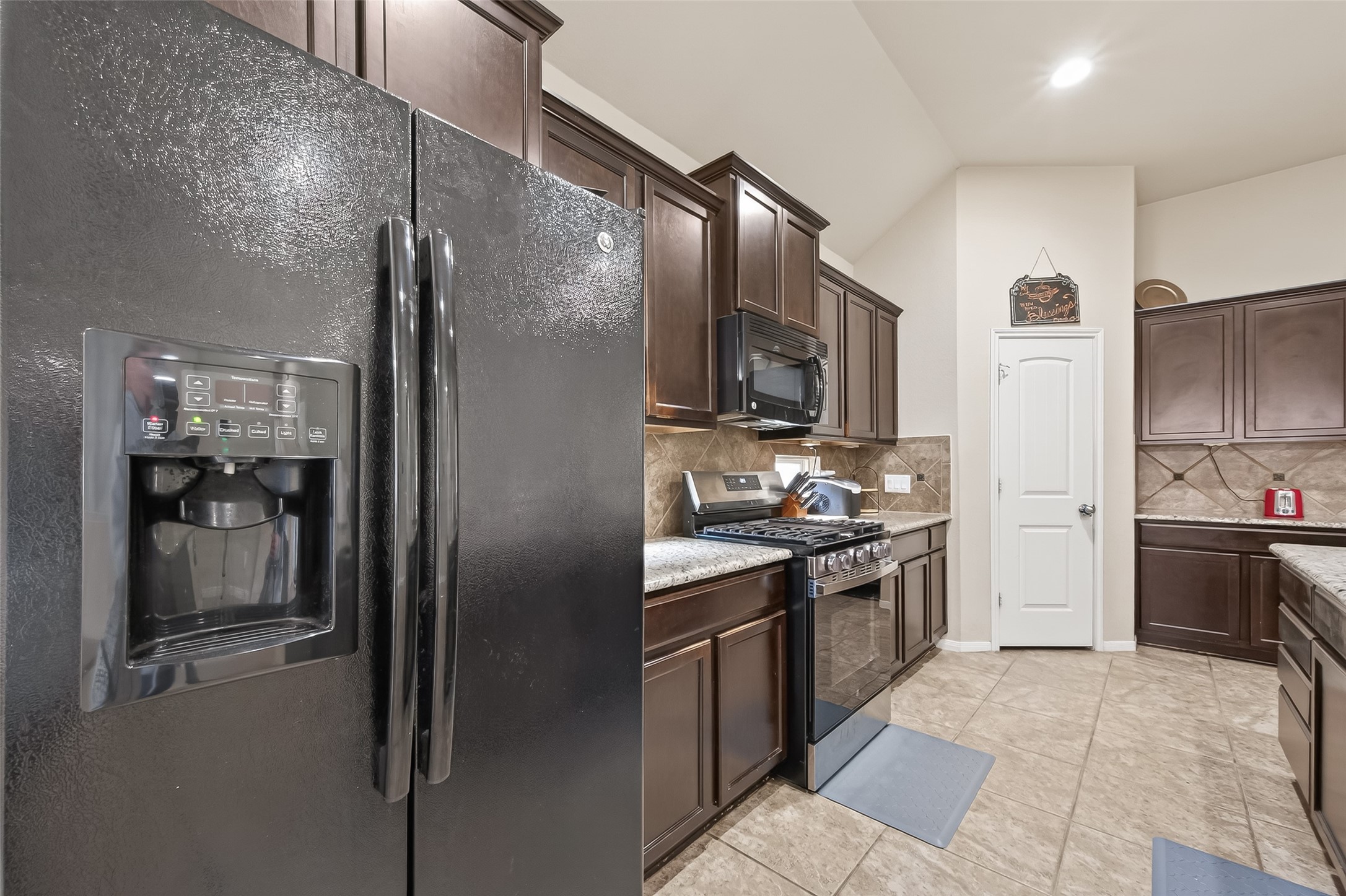 22530 Forbes Field Trail Spring, TX 77389 - Photo 20 of 50 a kitchen with stainless steel appliances granite countertop a refrigerator a stove a sink and a oven