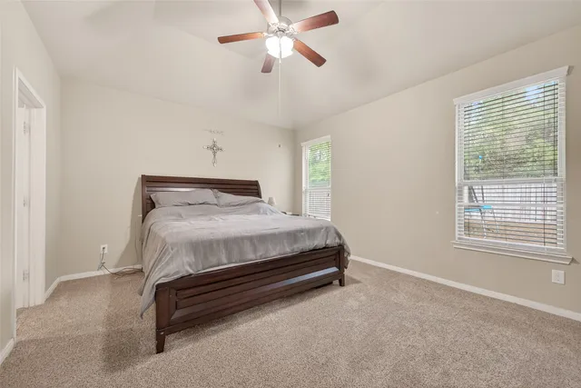 a bedroom with a bed dresser and a window