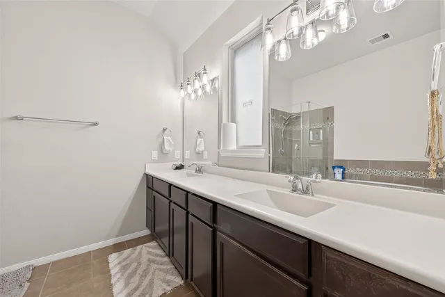 a bathroom with a sink double vanity and a mirror