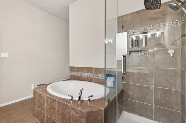 a bathroom with a tub and mirror