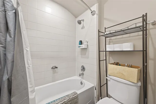 a bathroom with a bathtub and shower