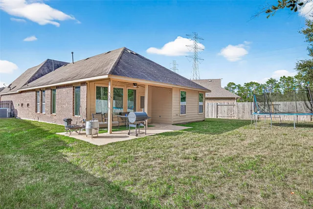 a view of a house with backyard and sitting area