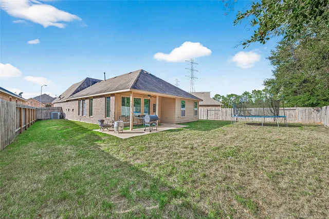 a view of a house with a yard and porch