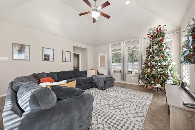 a living room with furniture flowers and a chandelier