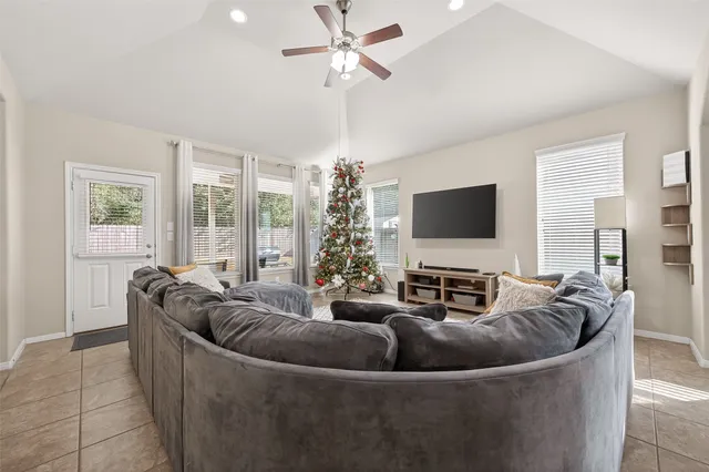 a living room with furniture and a flat screen tv