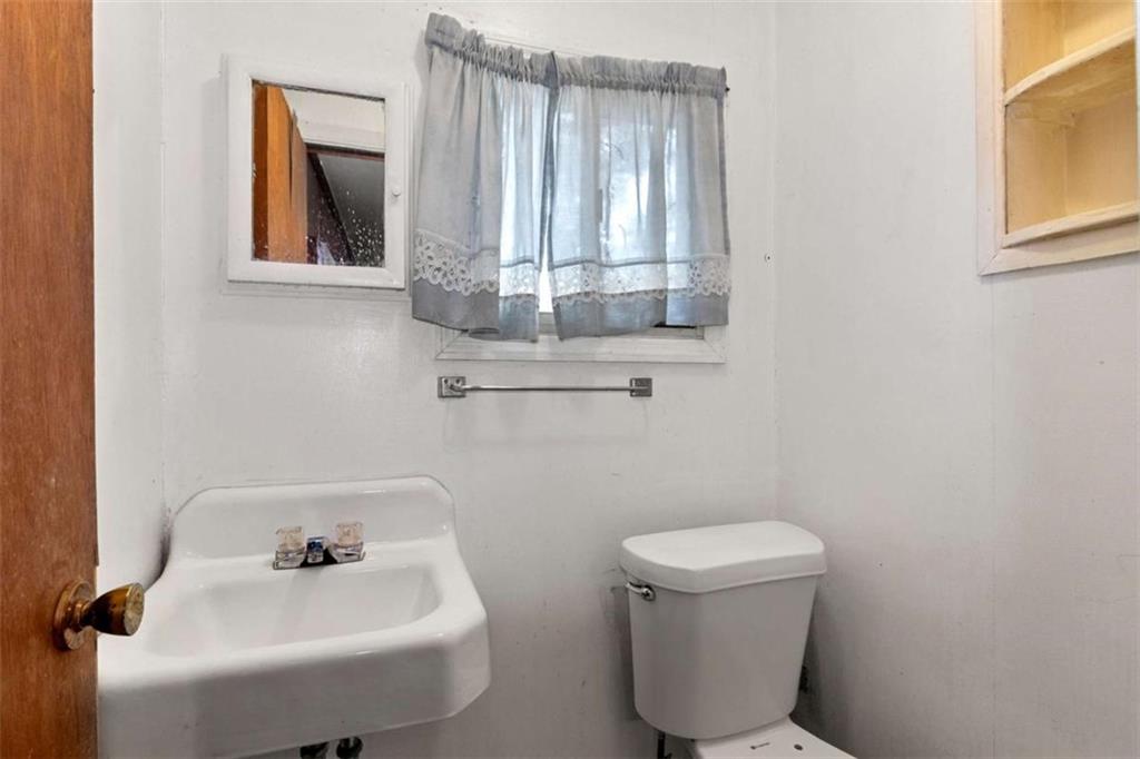 1638 Burton Avenue Macon, GA 31204 - Photo 12 of 15 a bathroom with a toilet sink and mirror
