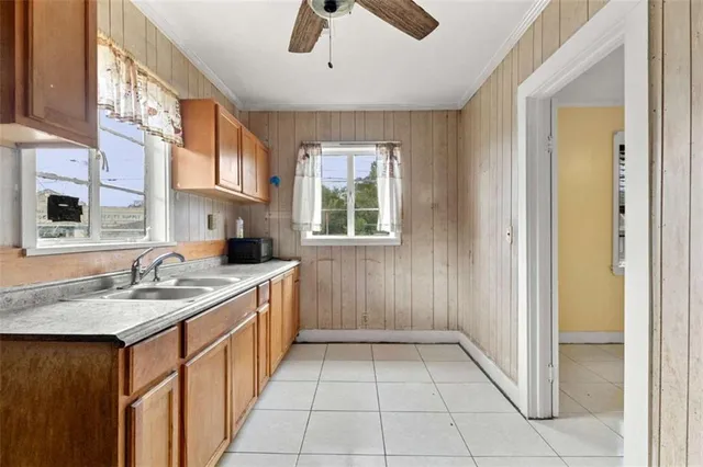 a kitchen with granite countertop a sink and a refrigerator