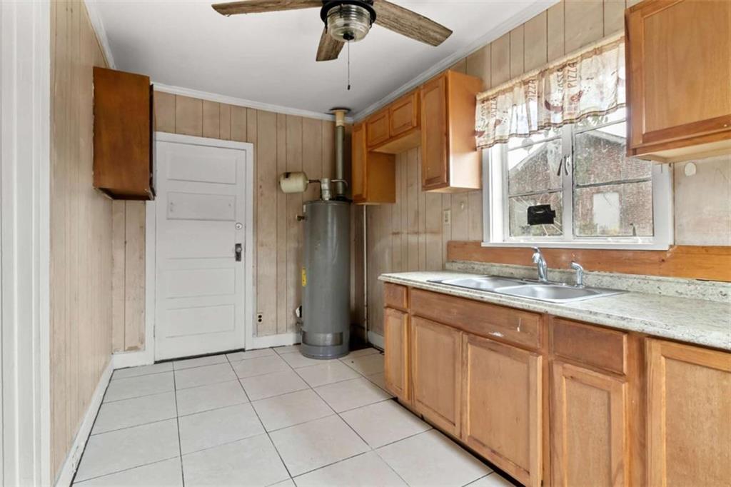 1638 Burton Avenue Macon, GA 31204 - Photo 7 of 15 a bathroom with a granite countertop sink a toilet and shower