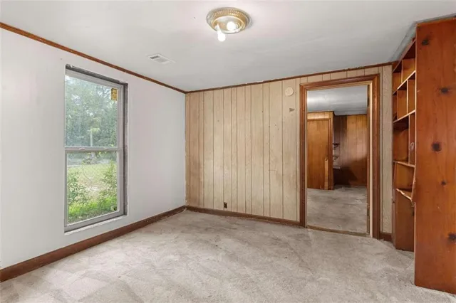 an empty room with windows and closet