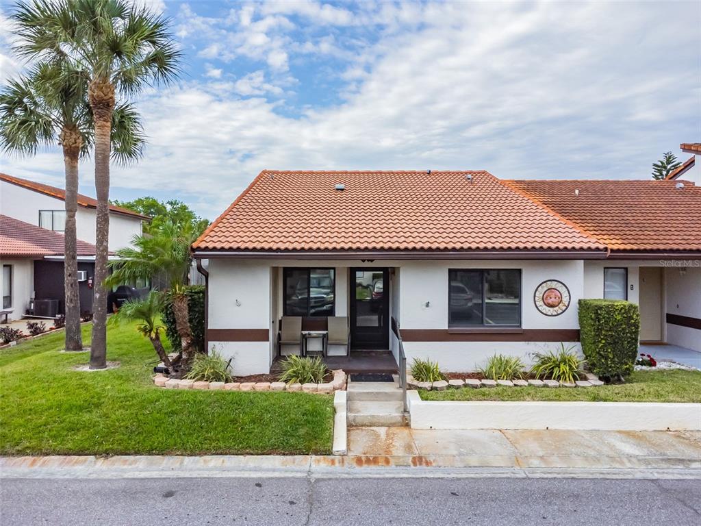 a front view of a house with garden