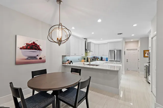 a bathroom with a granite countertop sink mirror and a shower